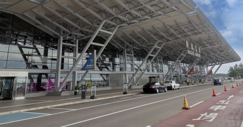 ガラス張りの近代的な新潟空港の外観と車寄せエリア