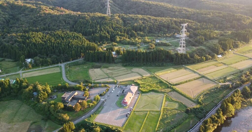 山間部に広がる田園と施設の航空写真